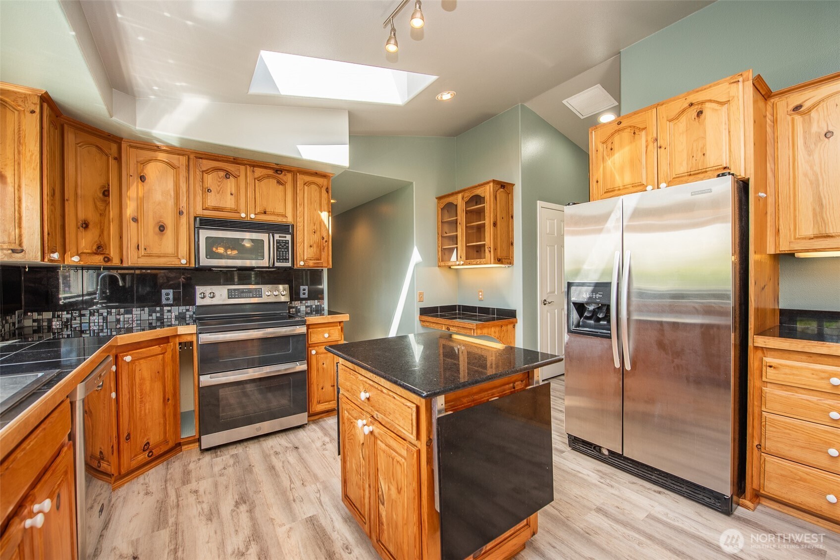 113 Gold Dust Lane Sequim, WA 98382 - Photo 16 of 40 a kitchen with stainless steel appliances granite countertop a refrigerator a sink and a stove