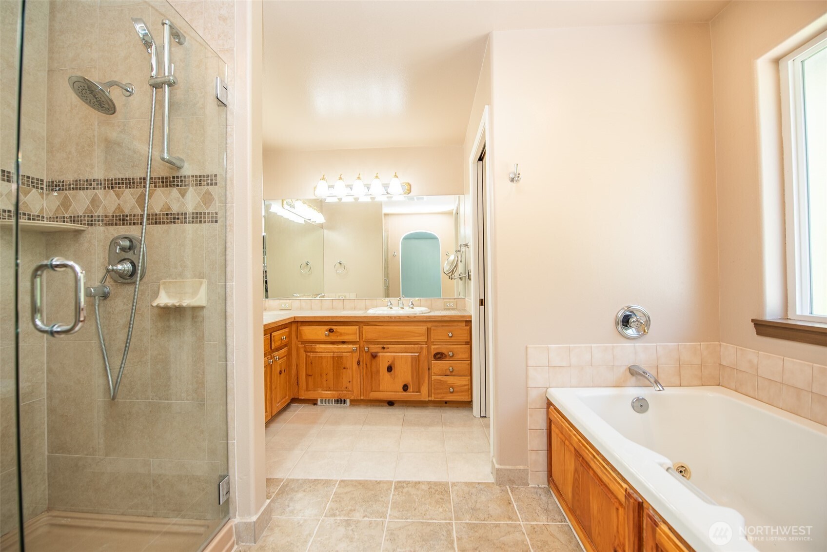 113 Gold Dust Lane Sequim, WA 98382 - Photo 21 of 40 a bathroom with a tub sink and mirror