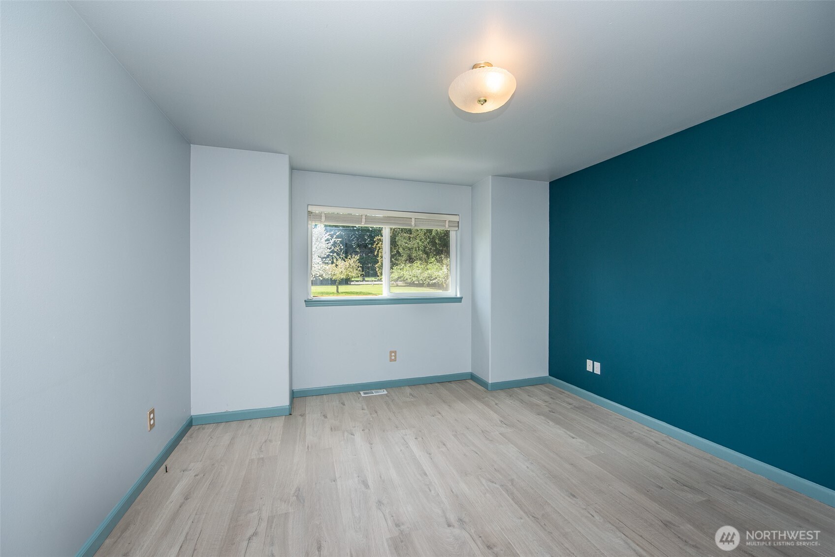 113 Gold Dust Lane Sequim, WA 98382 - Photo 25 of 40 an empty room with wooden floor and windows