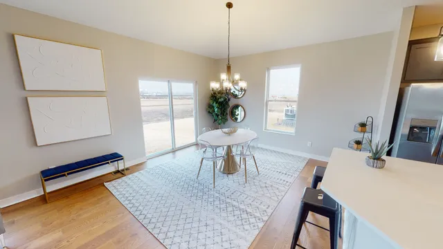 a dining room with table chairs and a chandelier
