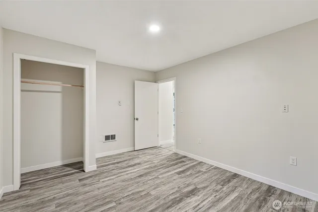 a view of a room with wooden floor