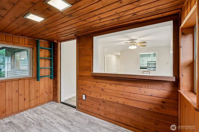 a view of front door with wooden floor and cabinet