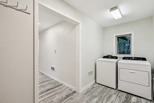 a view of a hallway with washer and dryer