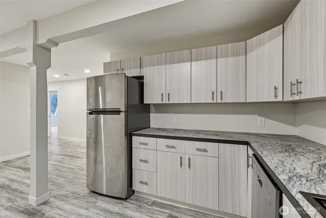 a kitchen with appliances cabinets and a counter top space