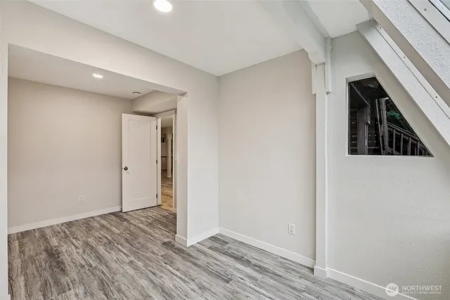 a view of hallway with wooden floor