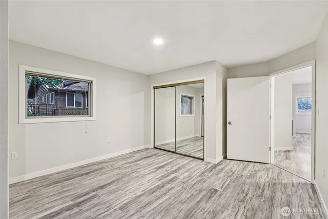 a view of a room with wooden floor and window