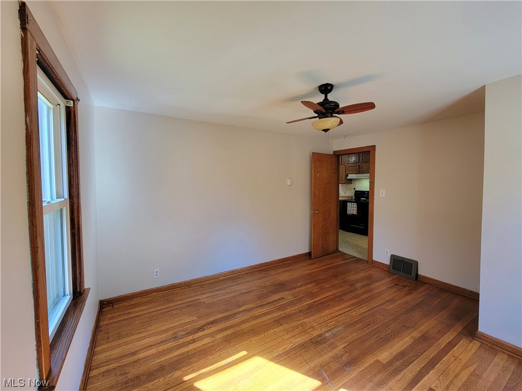 4506 Sandy Lake Road Ravenna, OH 44266 - Photo 14 of 32 Unfurnished room featuring dark hardwood floors and ceiling fan