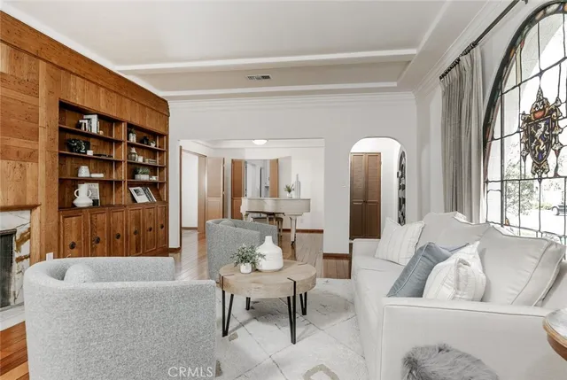 a view of a dining room with furniture a chandelier and wooden floor