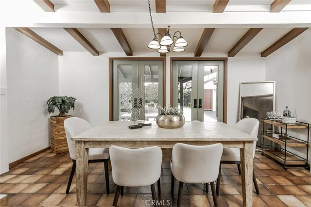 a living room with stainless steel appliances furniture a rug and a table