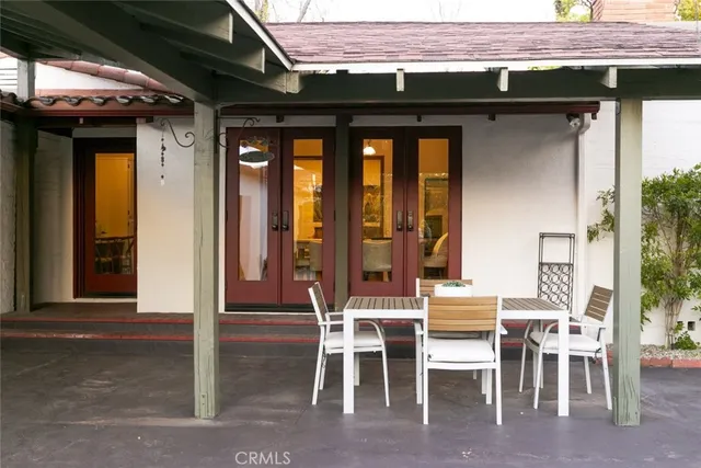 a backyard of a house with table and chairs