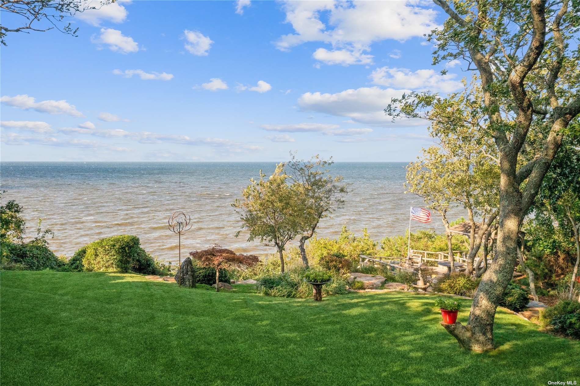 104 North Side Road Wading River, NY 11792 - Photo 1 of 1 a view of a garden with an ocean