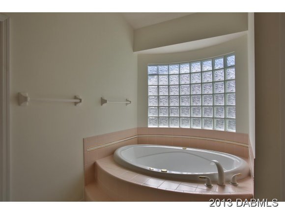 117 Inlet Harbor Road Ponce Inlet, FL 32127 - Photo 11 of 24 a view of bathroom with bathtub and window
