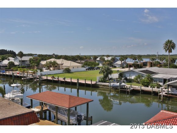 117 Inlet Harbor Road Ponce Inlet, FL 32127 - Photo 17 of 24 a view of a lake with a table and chairs