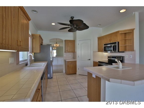 117 Inlet Harbor Road Ponce Inlet, FL 32127 - Photo 4 of 24 a kitchen with a sink appliances and cabinets