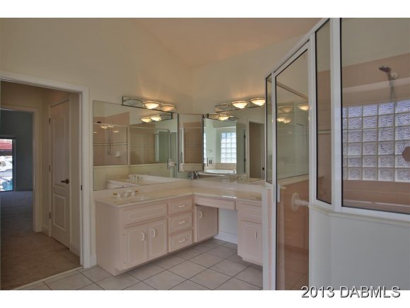117 Inlet Harbor Road Ponce Inlet, FL 32127 - Photo 10 of 24 a bathroom with a sink a large mirror and a shower