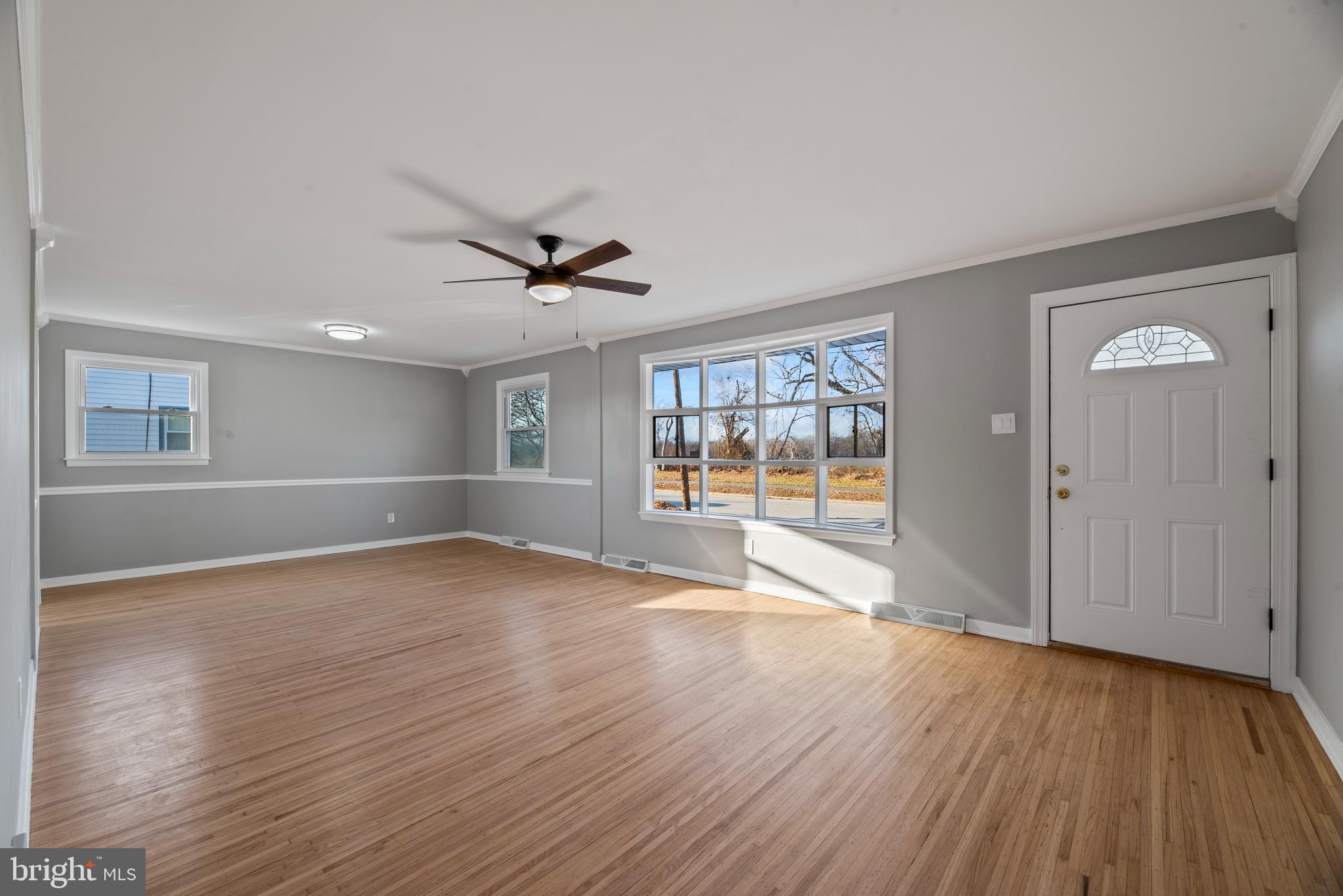 504 River Drive Riverside, NJ 08075 - Photo 5 of 45 a view of empty room with wooden floor and fan
