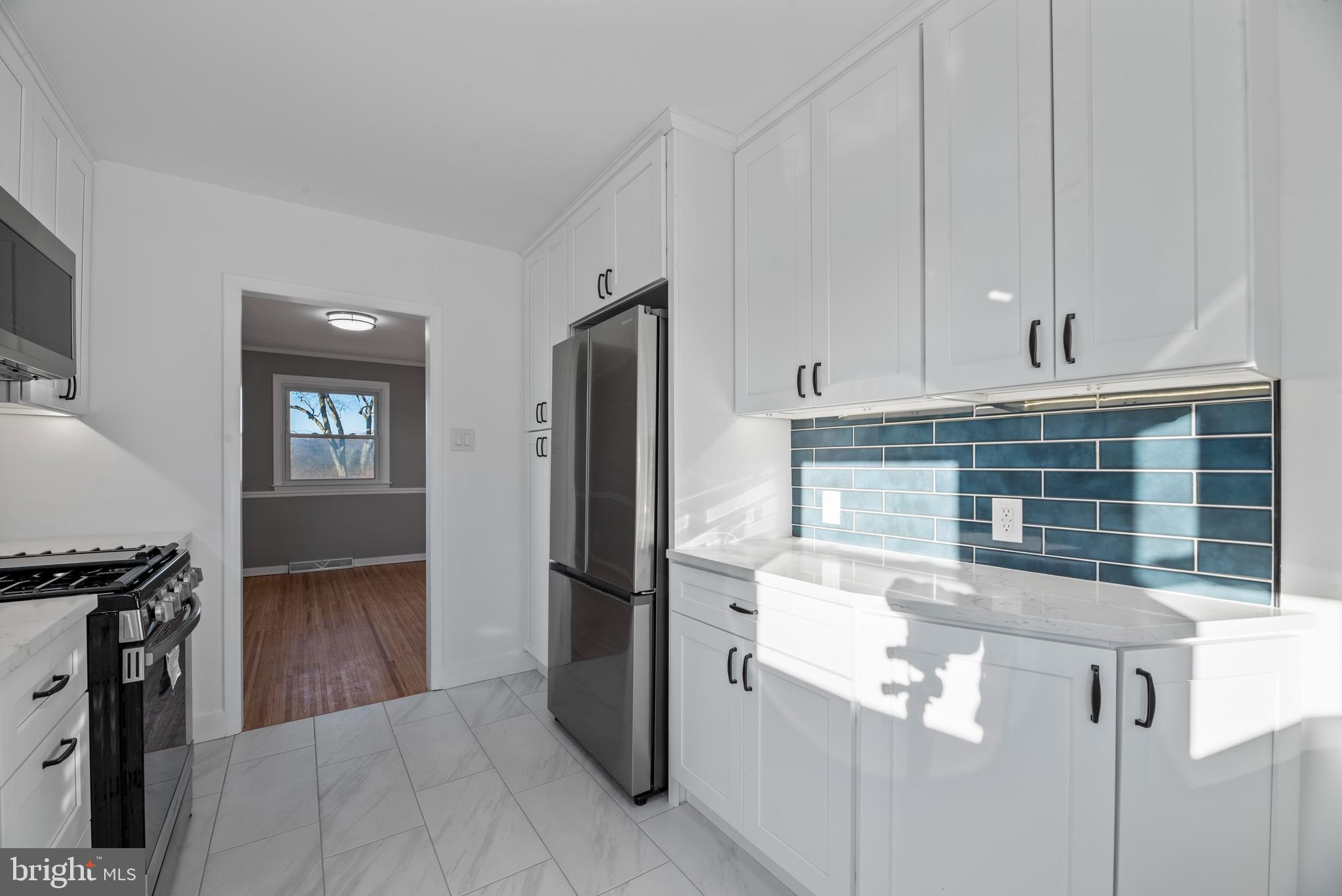 504 River Drive Riverside, NJ 08075 - Photo 8 of 45 a kitchen with a refrigerator and a stove top oven