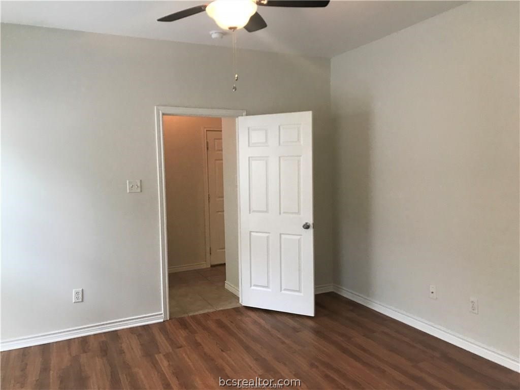3754 Essen Loop College Station, TX 77845 - Photo 15 of 25 an empty room with wooden floor and chandelier fan