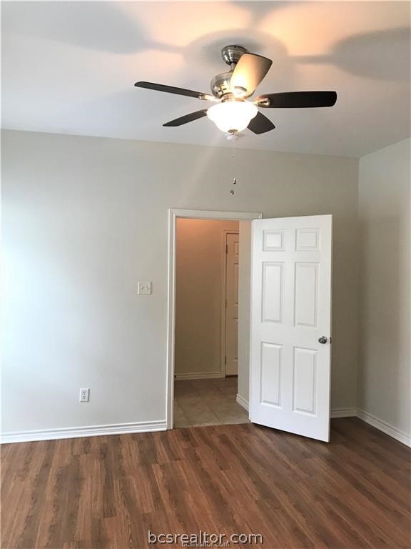 3754 Essen Loop College Station, TX 77845 - Photo 17 of 25 an empty room with wooden floor chandelier fan and windows