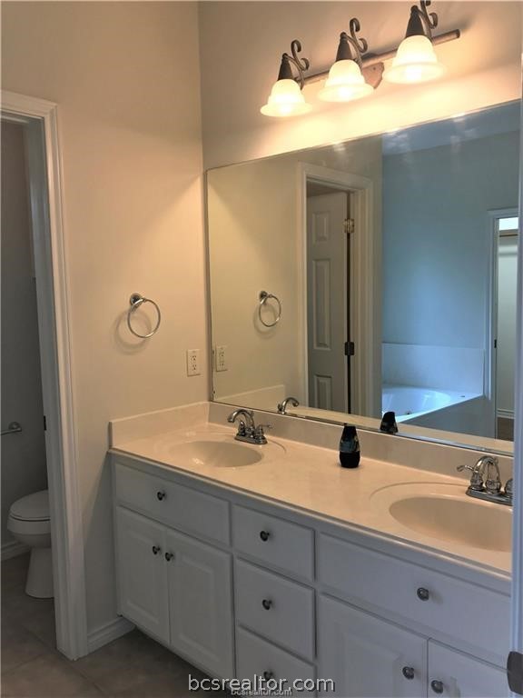 3754 Essen Loop College Station, TX 77845 - Photo 18 of 25 a bathroom with a double vanity sink and mirror with shower