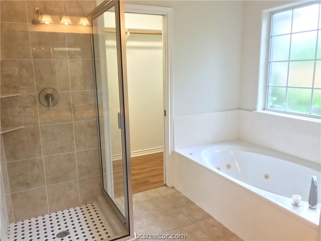 3754 Essen Loop College Station, TX 77845 - Photo 19 of 25 a bathroom with a bathtub and a shower