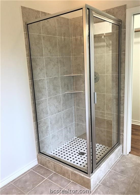 3754 Essen Loop College Station, TX 77845 - Photo 20 of 25 a bathroom with a glass shower door