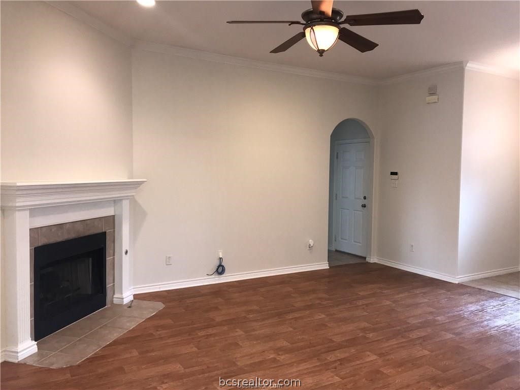 3754 Essen Loop College Station, TX 77845 - Photo 4 of 25 an empty room with chandelier fan and fireplace