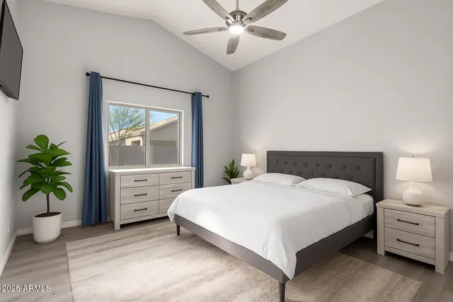a bedroom with a bed and a potted plant