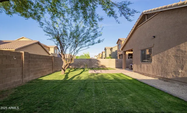 a view of backyard of house with green space