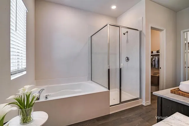 a bathroom with a tub shower and sink