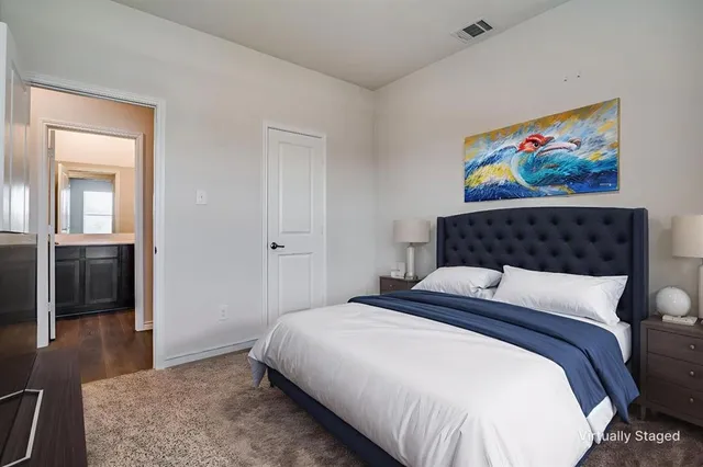 a bedroom with bed and wall painting