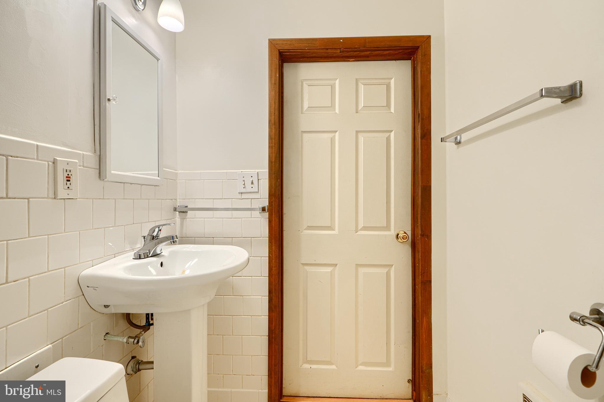 7703 Meath Road Dundalk, MD 21222 - Photo 14 of 45 a bathroom with a sink and a mirror