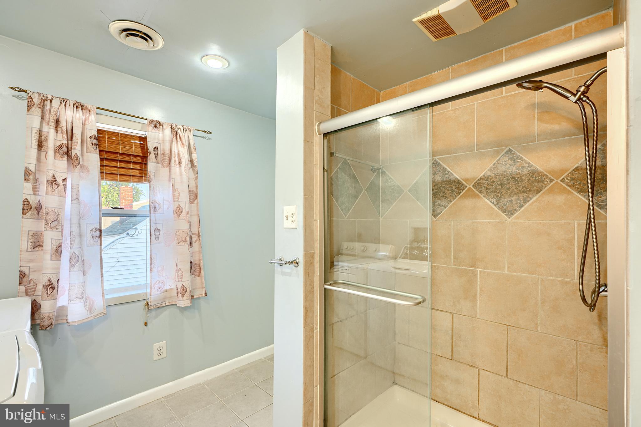 7703 Meath Road Dundalk, MD 21222 - Photo 33 of 45 a bathroom with a bathtub and a shower