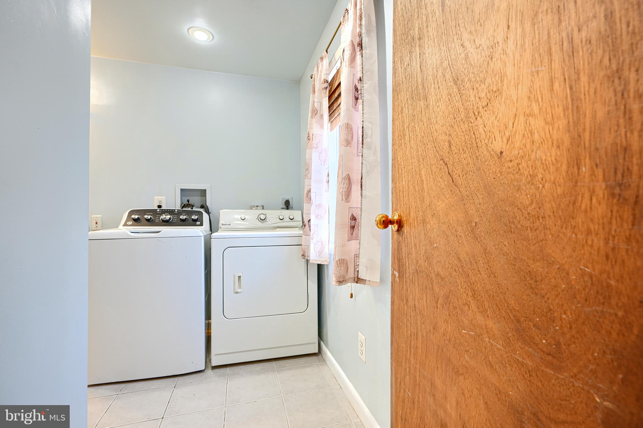 7703 Meath Road Dundalk, MD 21222 - Photo 34 of 45 a utility room with dryer and washer