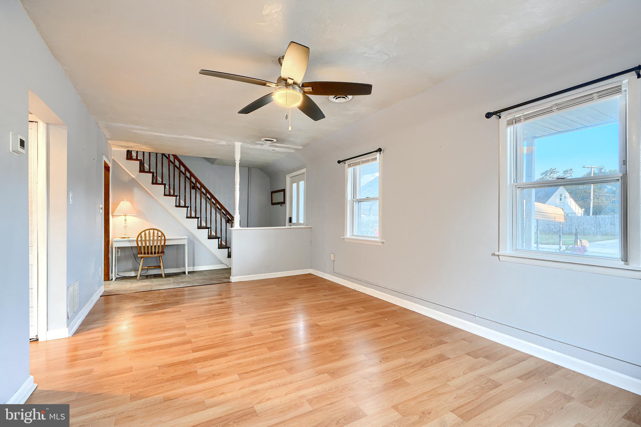 7703 Meath Road Dundalk, MD 21222 - Photo 9 of 45 a view of an empty room with wooden floor and a window