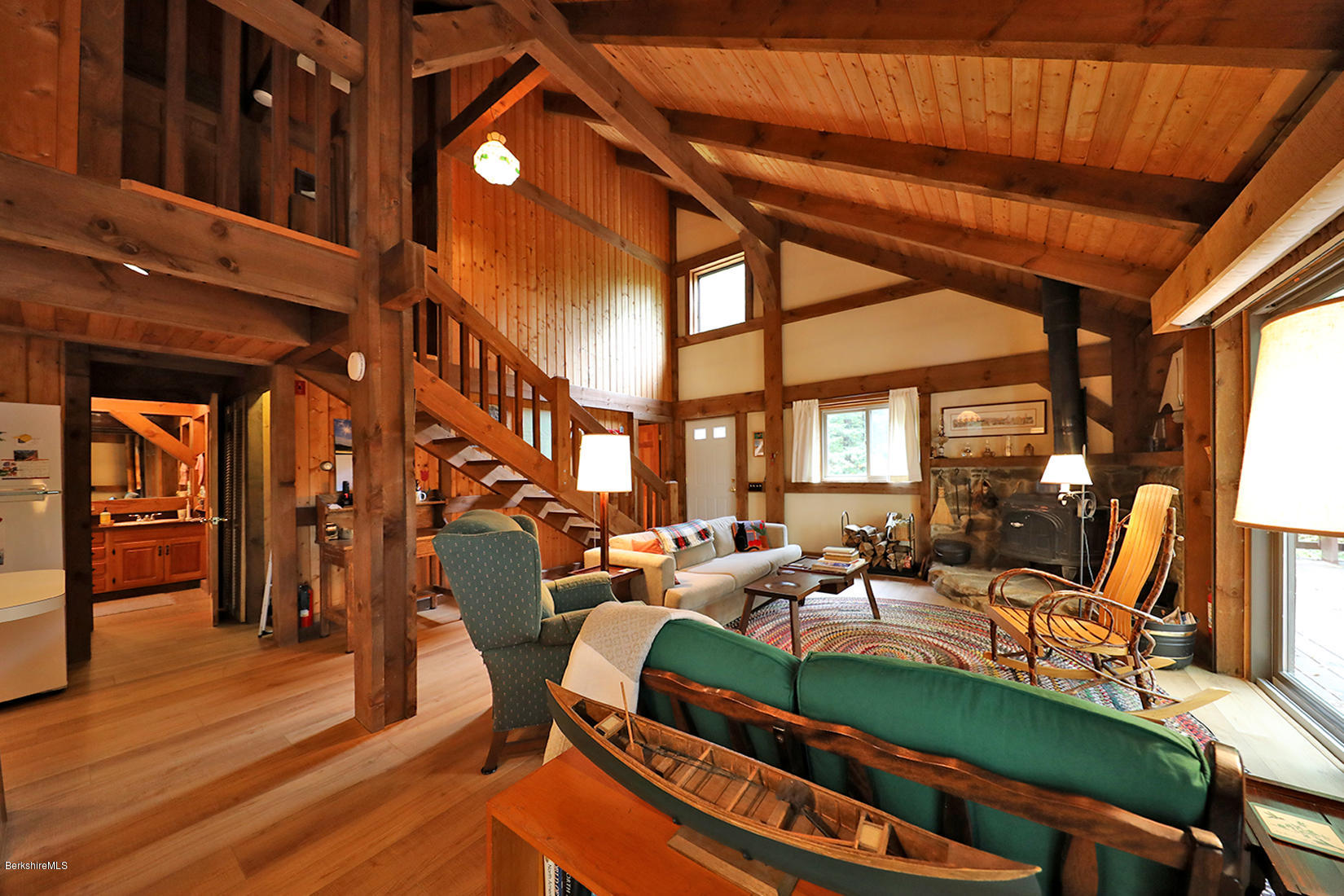 66 Ray Hubbard Road Otis, MA 01029 - Photo 3 of 21 a living room with furniture a fireplace and wooden floor