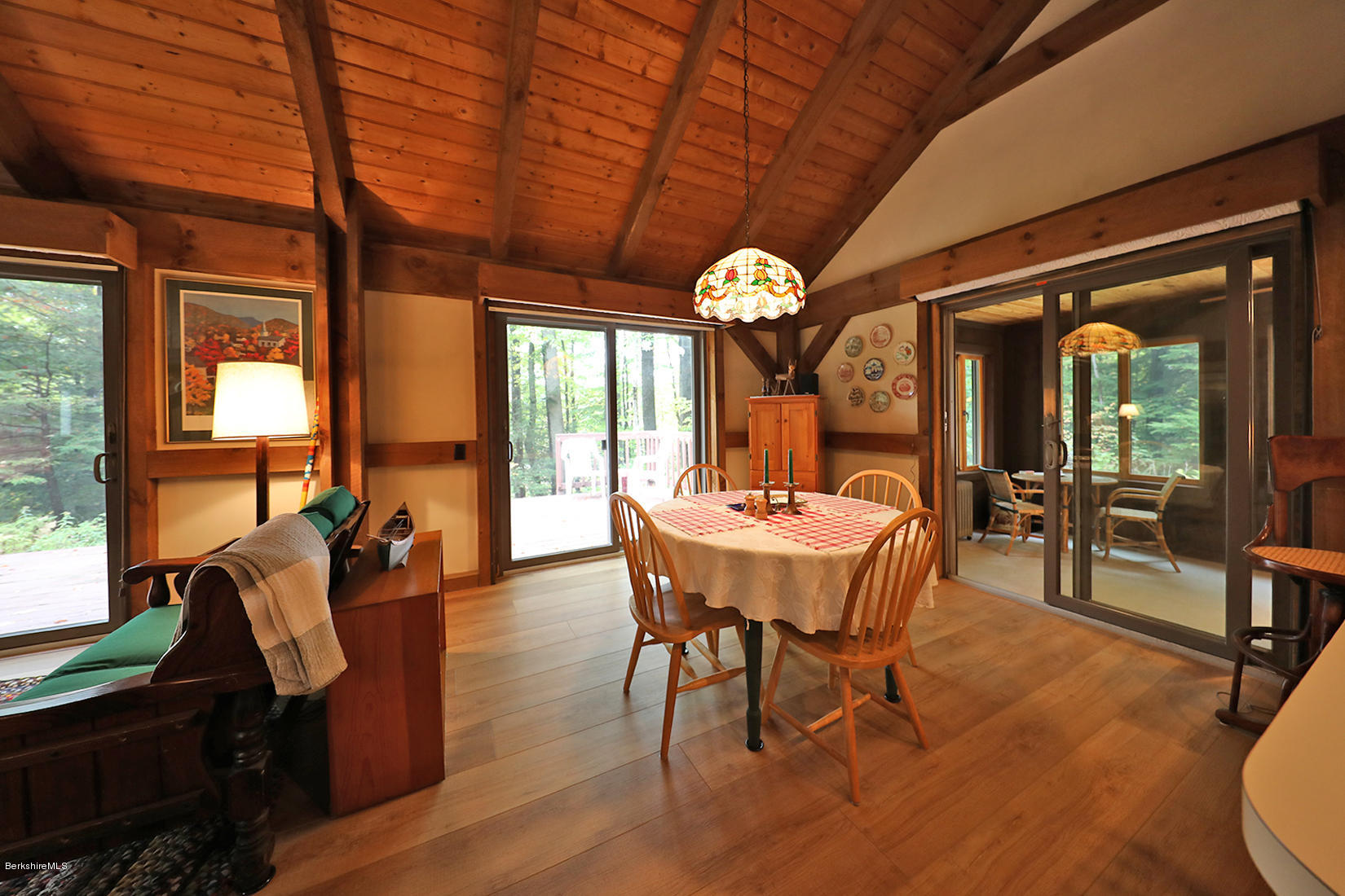 66 Ray Hubbard Road Otis, MA 01029 - Photo 5 of 21 a dining room with furniture a chandelier and wooden floor