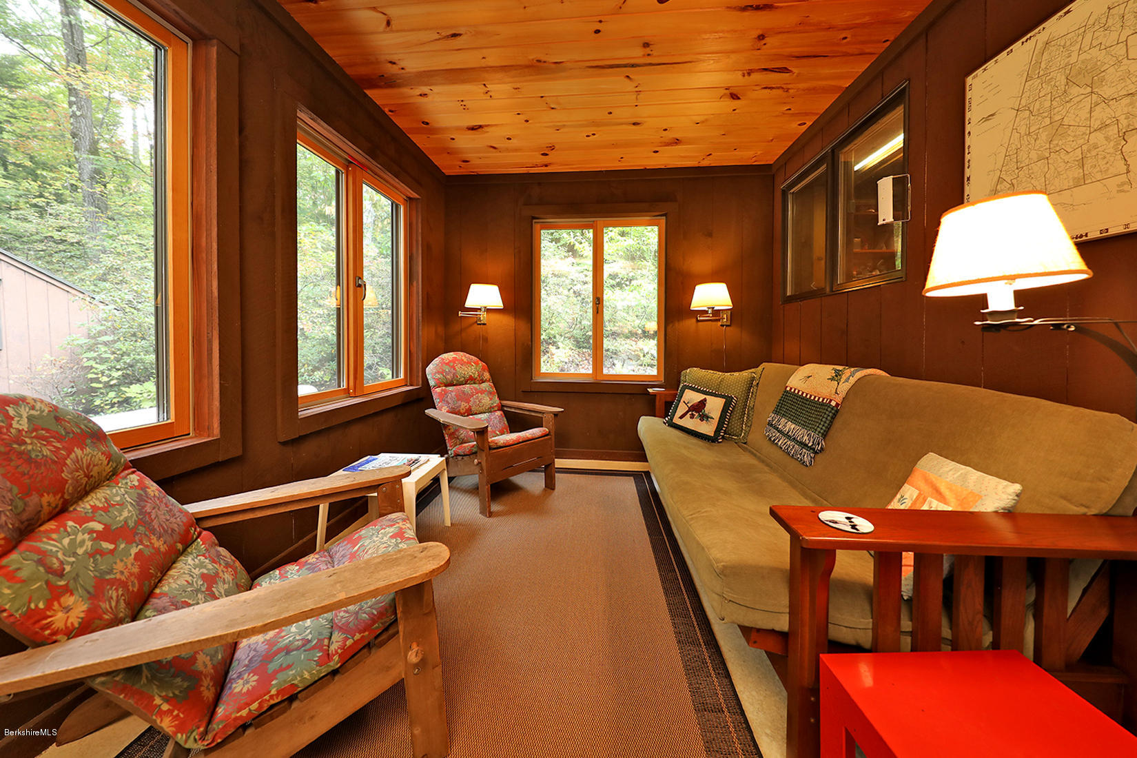 66 Ray Hubbard Road Otis, MA 01029 - Photo 7 of 21 a living room with furniture a large window and potted plants