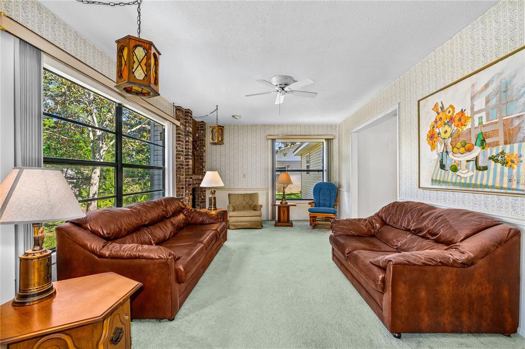693 Reillys Road Port Orange, FL 32127 - Photo 12 of 31 a living room with furniture a couch and a window