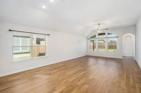 a view of a livingroom with wooden floor and a window