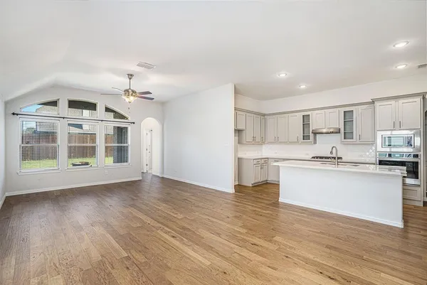 a view of kitchen with granite countertop cabinets and wooden floor