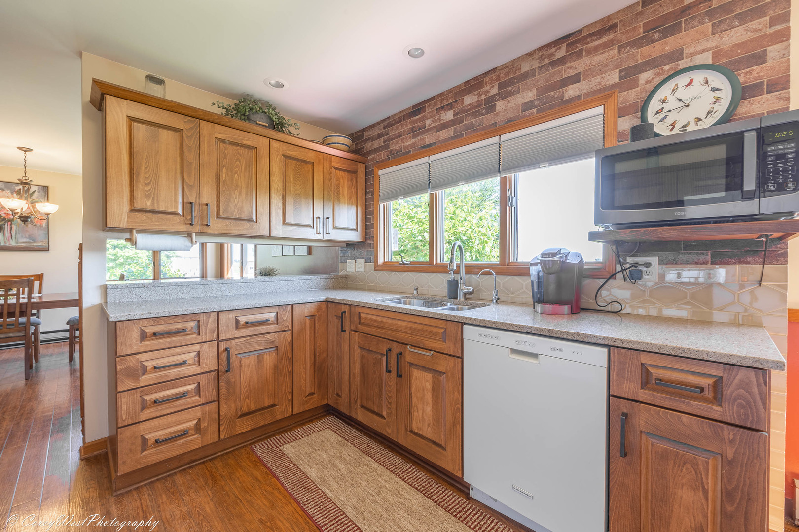 35450 Genoa Road Genoa, IL 60135 - Photo 20 of 41 a kitchen with stainless steel appliances granite countertop a sink and cabinets with wooden floor