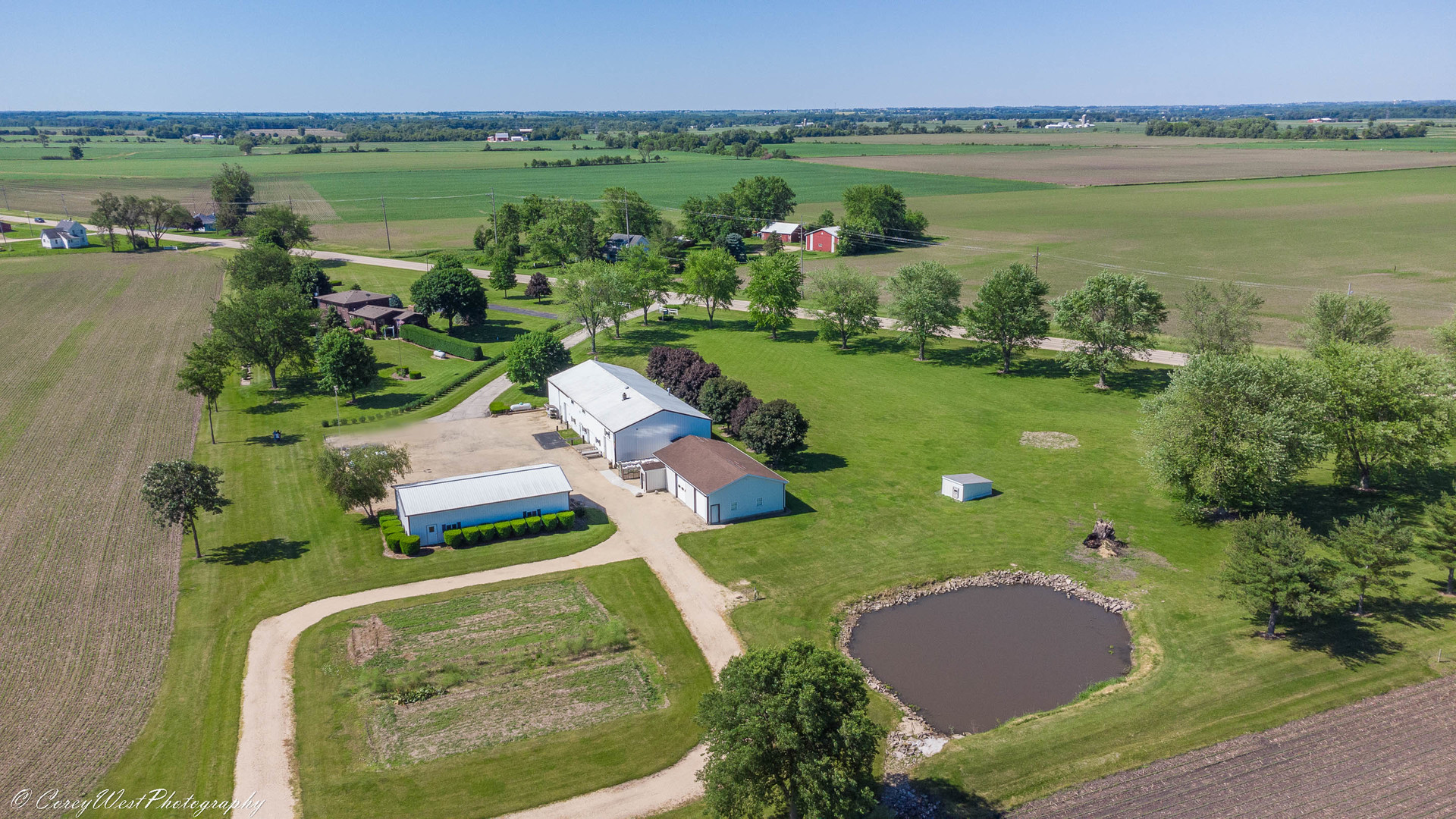 35450 Genoa Road Genoa, IL 60135 - Photo 6 of 41 an aerial view of a house with a garden and lake view