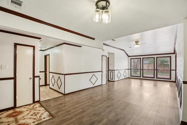 a view of a livingroom with a ceiling fan and wooden floor