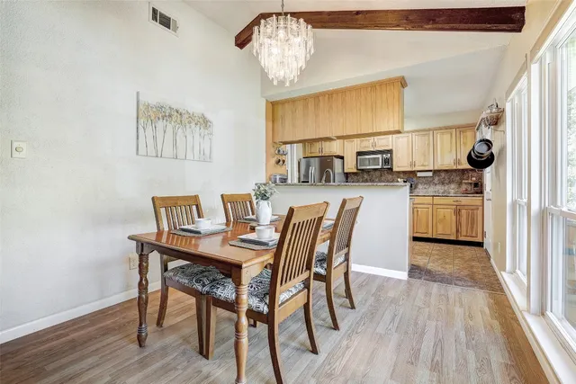 a view of a dining room with furniture and wooden floor