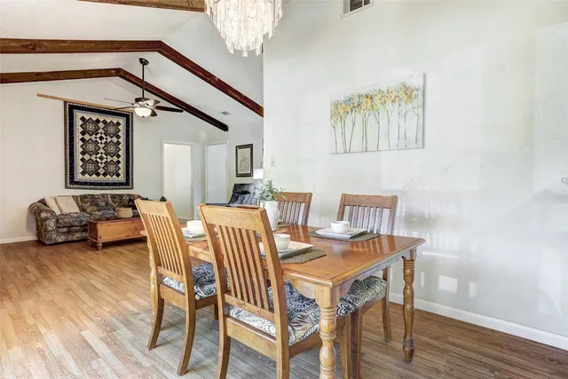 a view of a a dining room with furniture and wooden floor