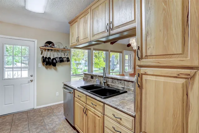 a kitchen with stainless steel appliances granite countertop a sink and a cabinets