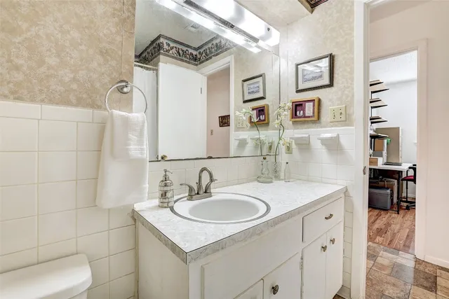 a bathroom with a sink toilet and shower