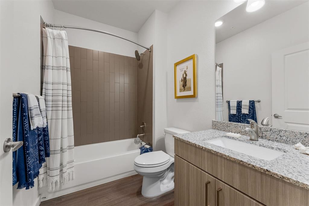13301 Dessau Road, Unit 7203 Austin, TX 78754 - Photo 10 of 17 a bathroom with a granite countertop sink toilet and shower