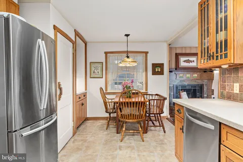 a dining room with furniture a chandelier and wooden floor